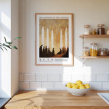a framed poster of silhouettes of people in a church, hanging on a wall above a wooden counter with a bowl of lemons.