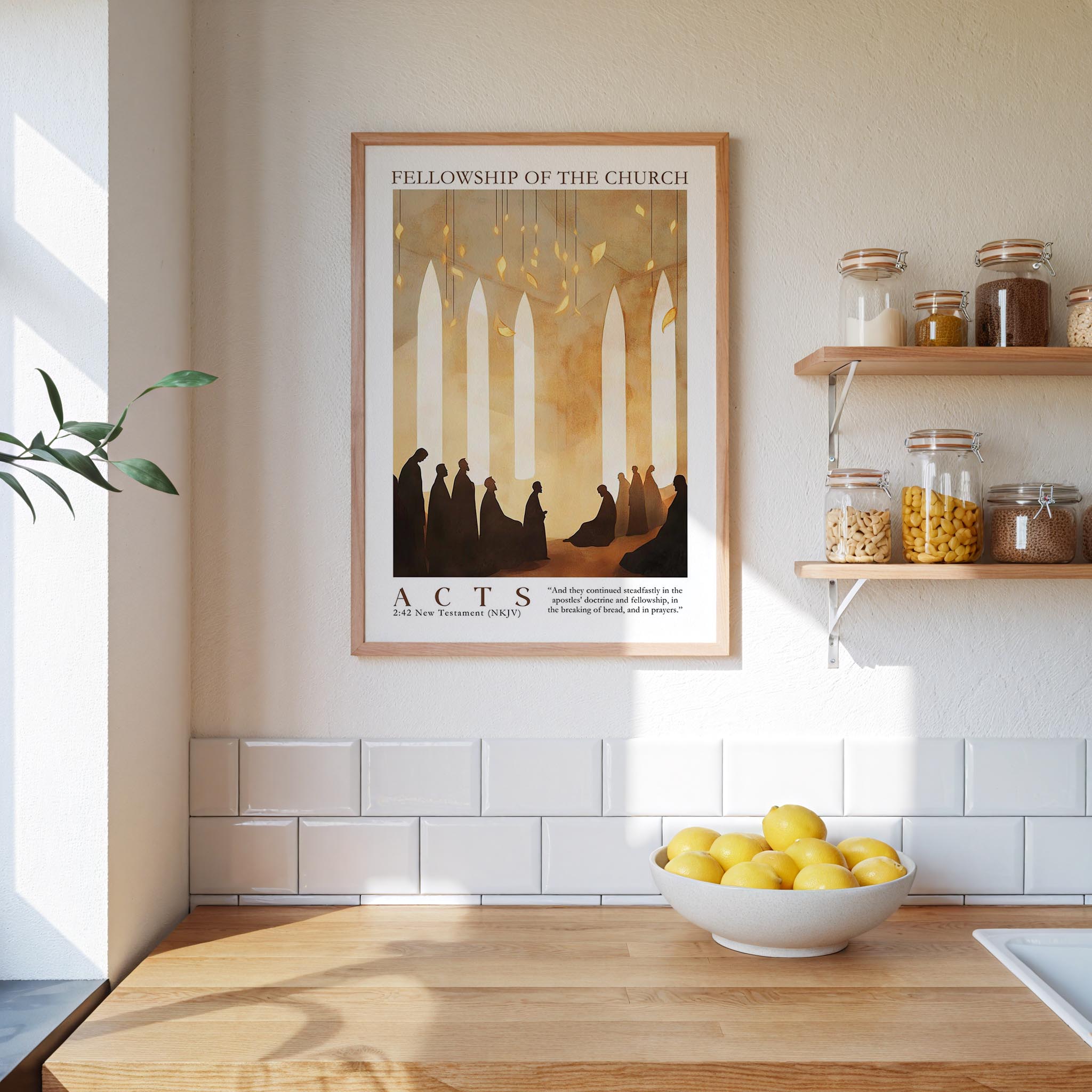 a framed poster of silhouettes of people in a church, hanging on a wall above a wooden counter with a bowl of lemons.