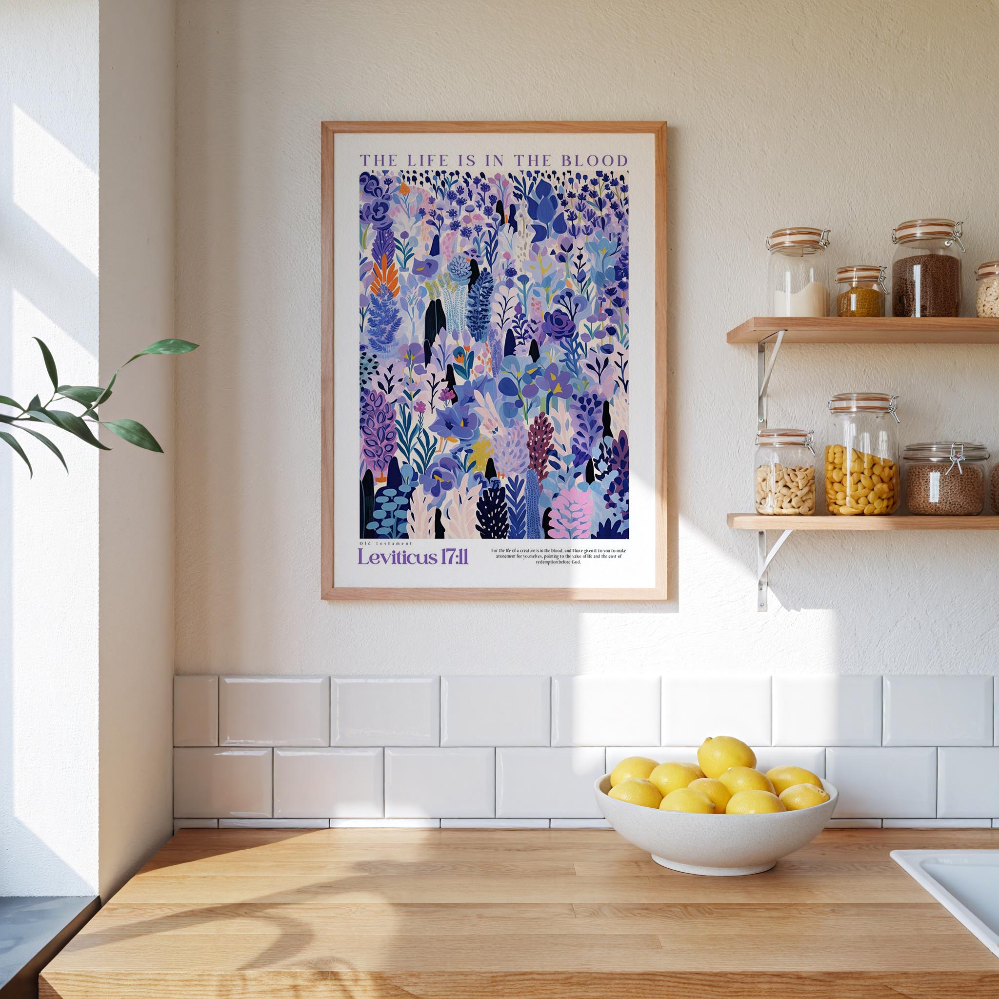 a kitchen scene with a framed poster of a colorful floral pattern hanging on the wall above a wooden countertop with a bowl of lemons.