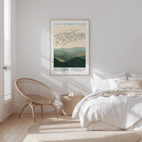 a serene bedroom scene with a large bed, a woven chair, and a framed poster of birds in flight above it.
