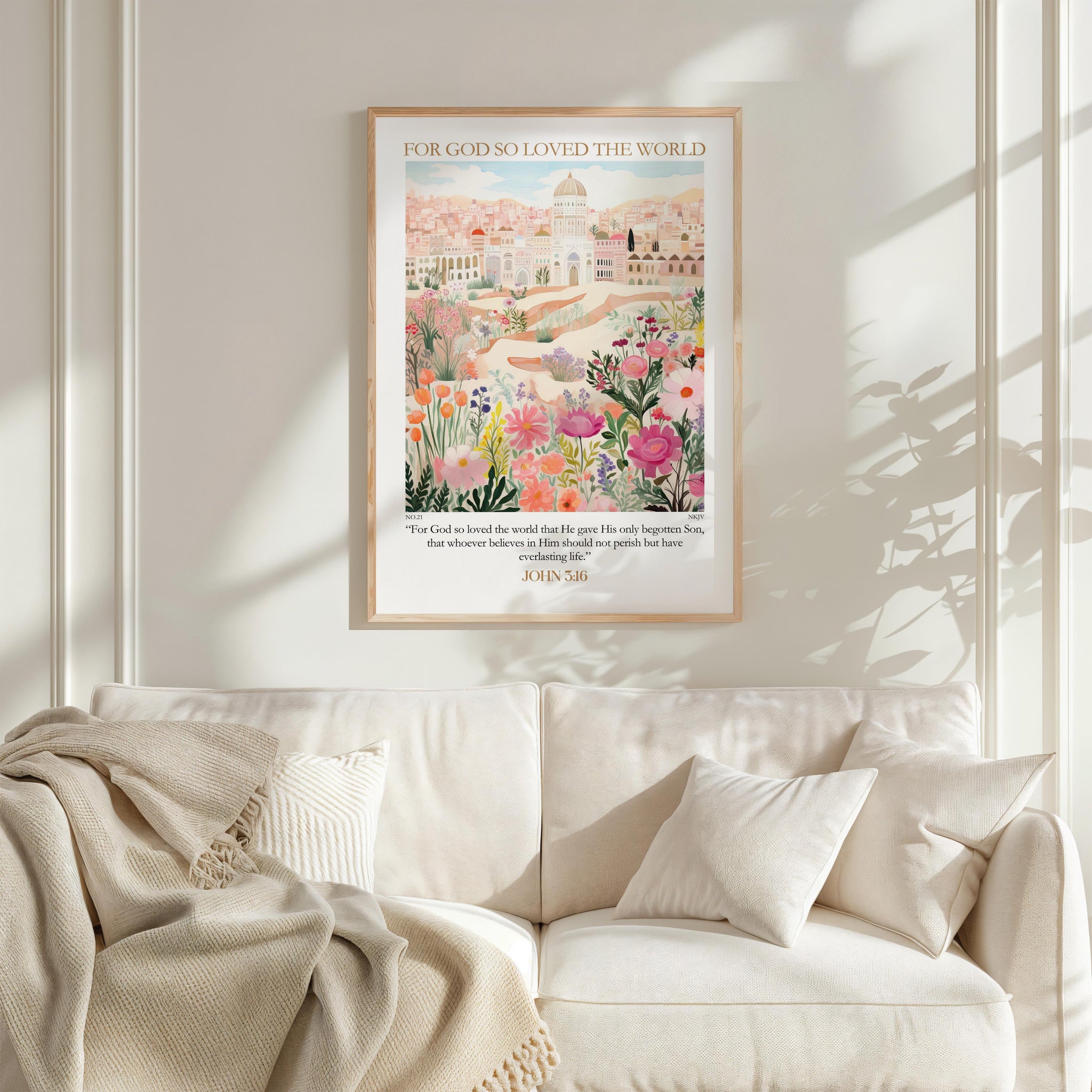 a cozy living room with a white sofa and a framed poster of a cityscape with flowers hanging on the wall above it.