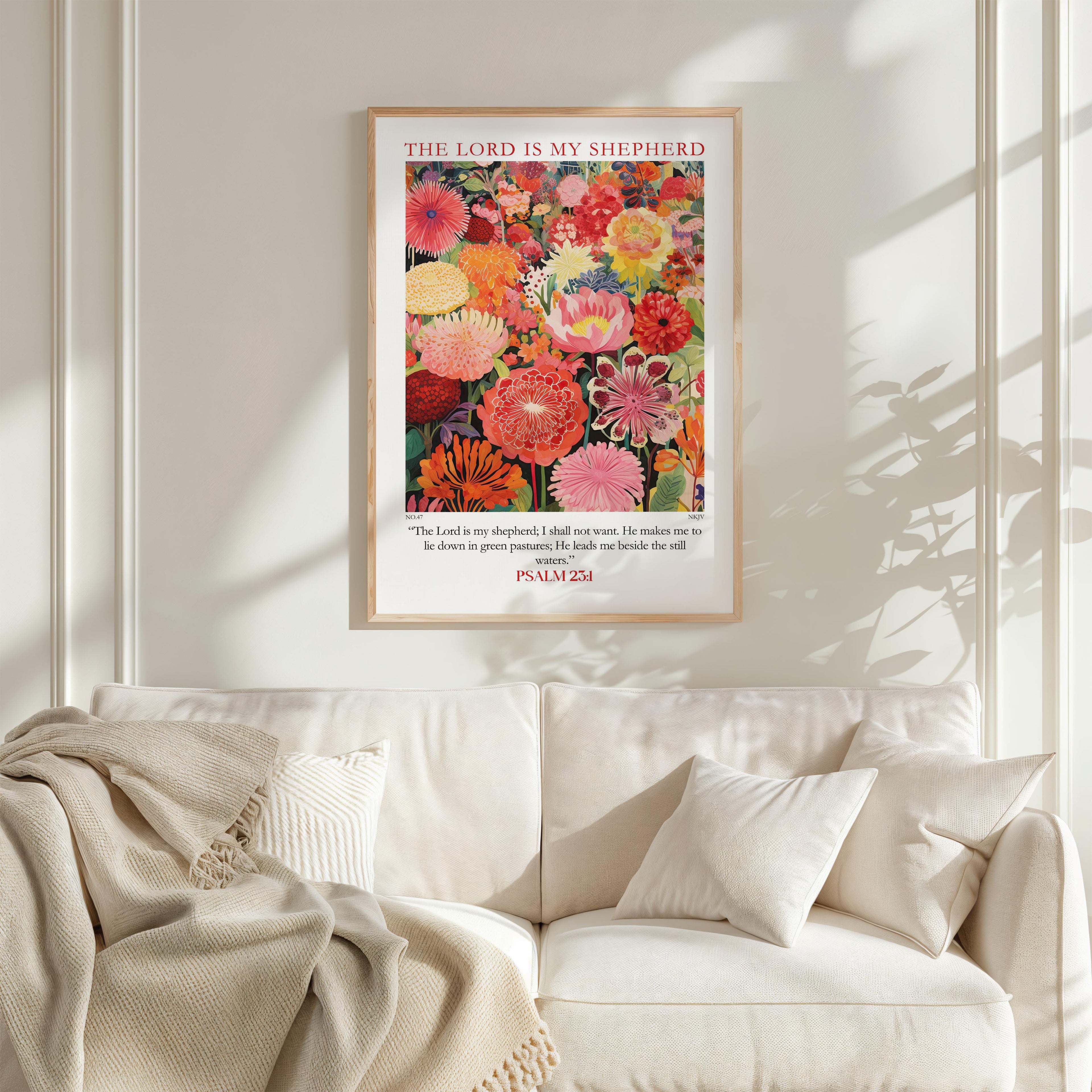 a framed poster of a vibrant floral arrangement hanging on a white wall above a white couch.