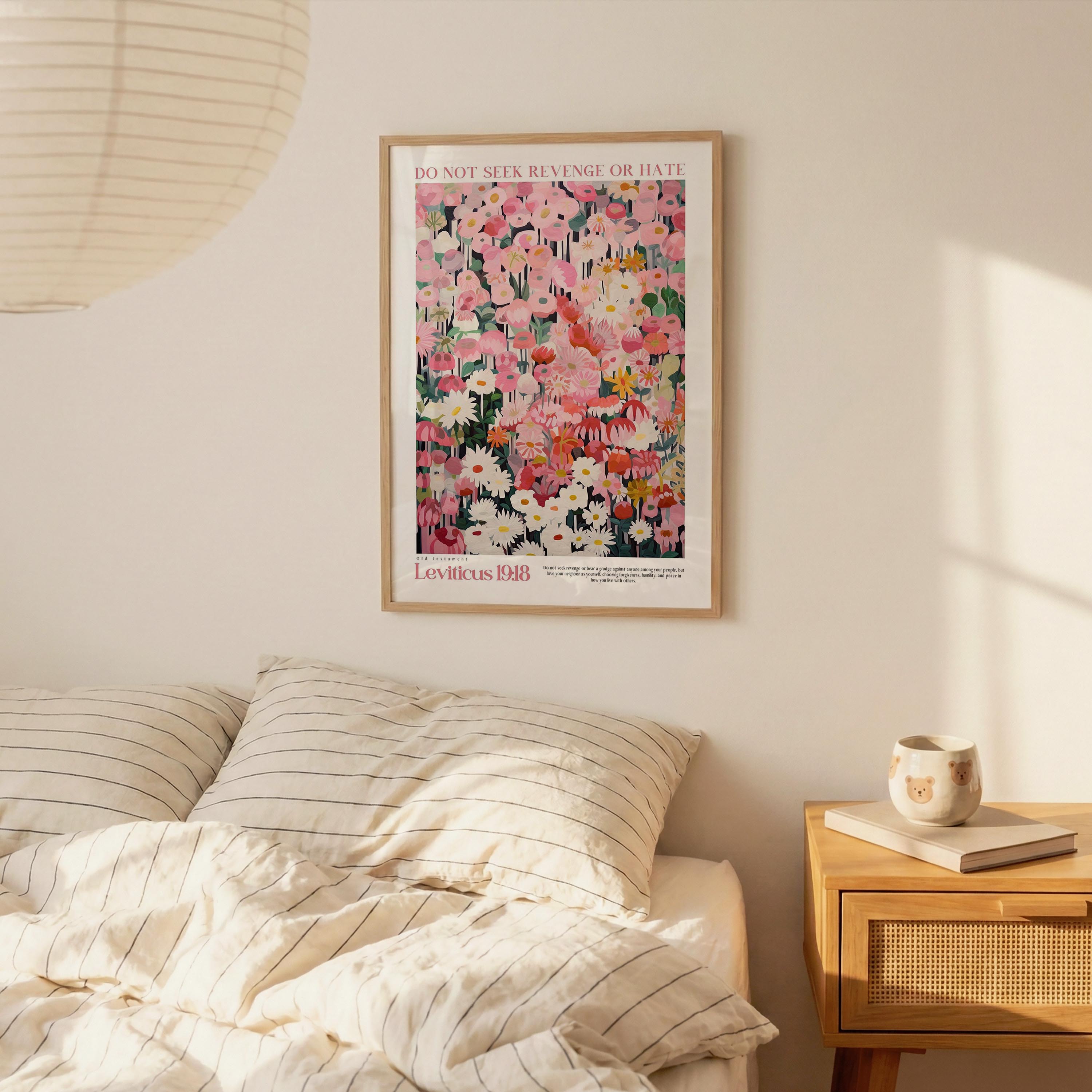 a bedroom scene with a framed poster of a colorful floral design hanging on the wall above a bed with striped pillows.