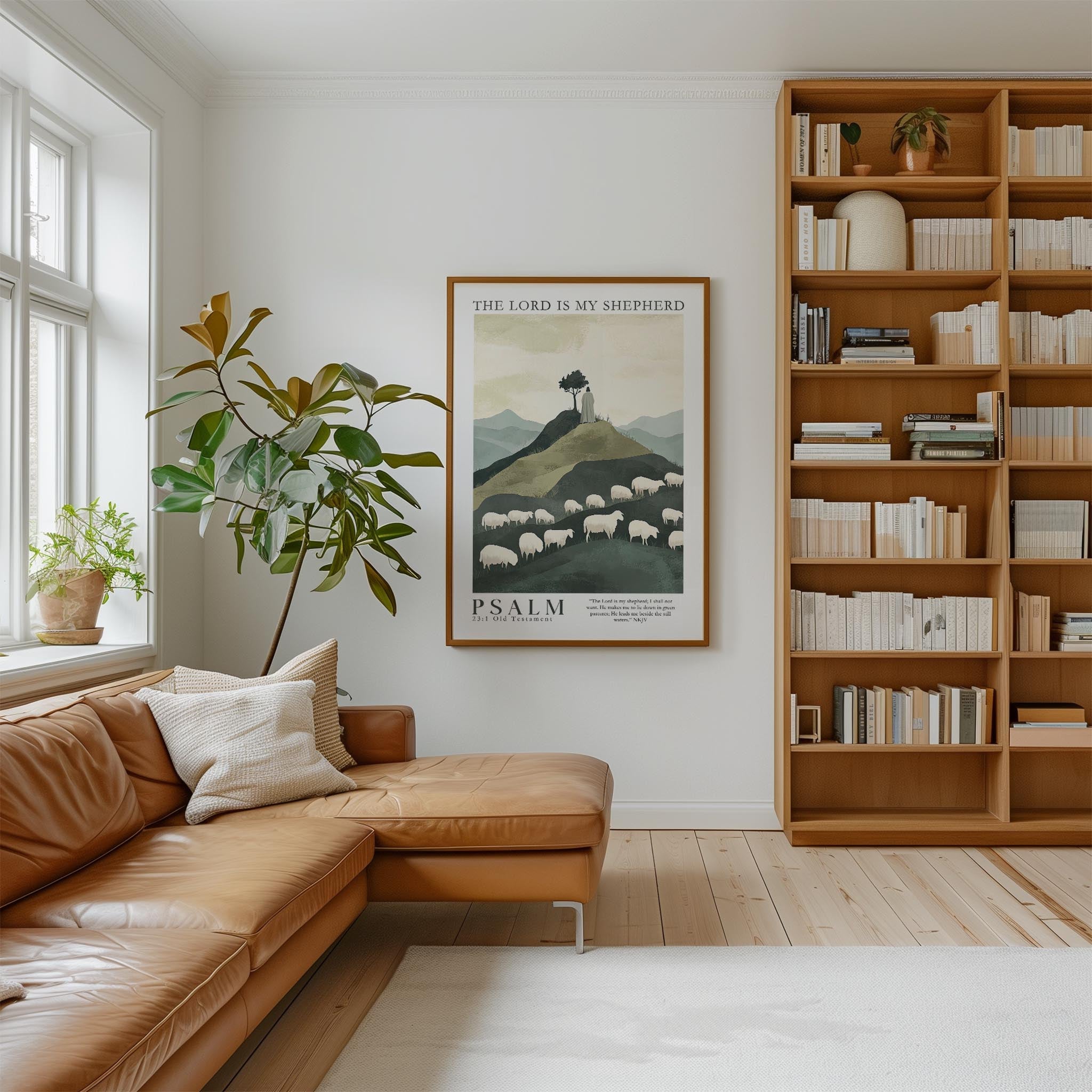 a cozy living room with a large bookshelf filled with books, a comfortable leather couch, and a framed poster of sheep on the wall.