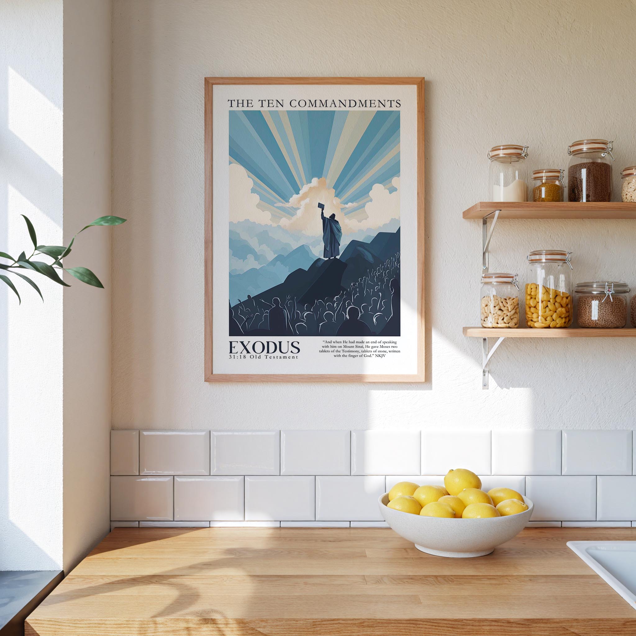 a framed poster of the Ten Commandments hanging on a wall above a kitchen counter with a bowl of lemons and a plant.