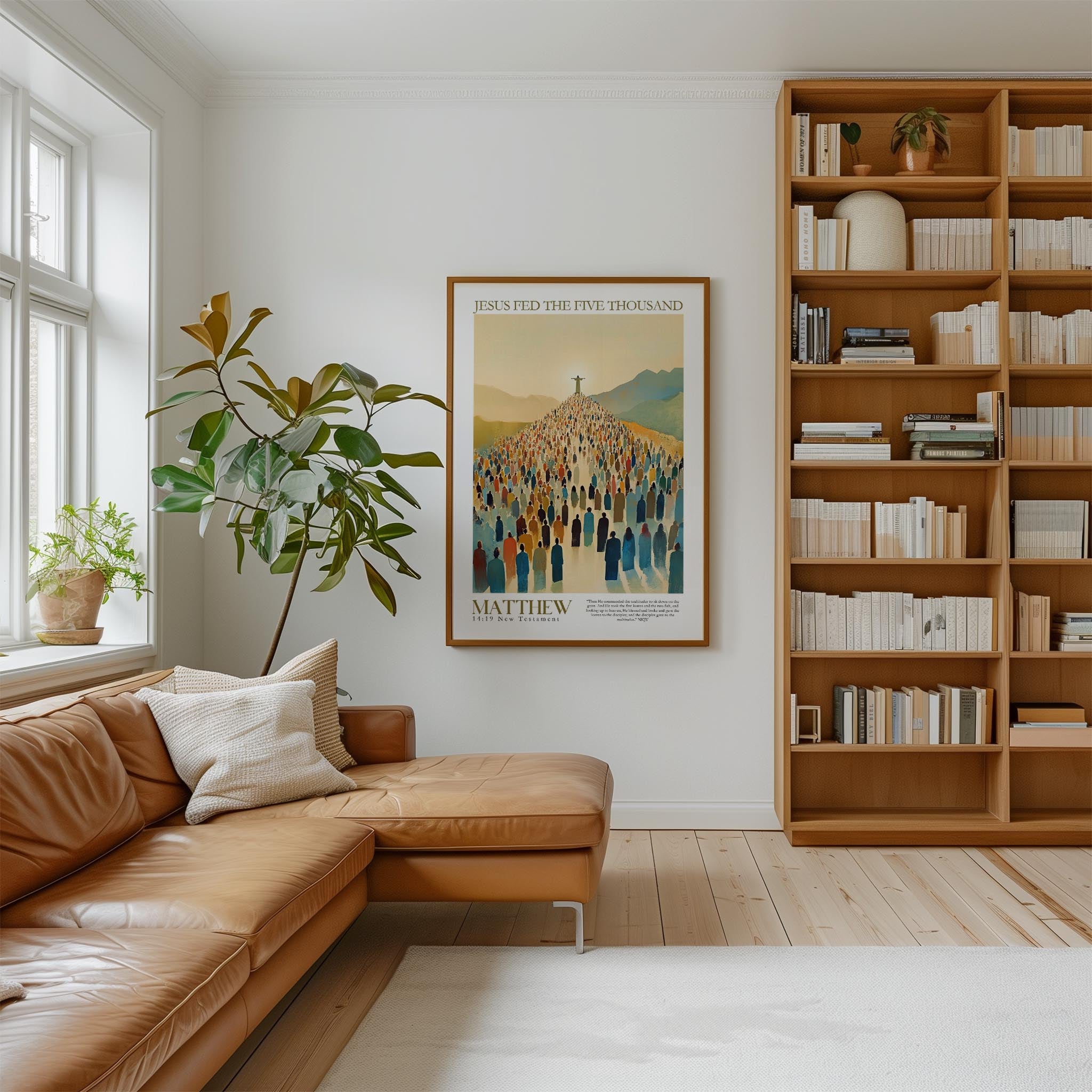 a cozy living room with a large bookshelf filled with books, a comfortable leather couch, and a framed poster of a crowd of people on the wall.
