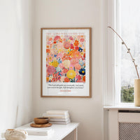 a framed poster of a colorful floral design hanging on a wall, with a quote from Isaiah 58:1-3 displayed below the poster.