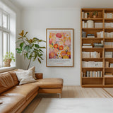 a cozy living room with a brown leather sofa, a large bookshelf filled with books, and a framed poster of a colorful floral design hanging on the wall.