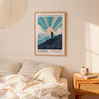 a framed poster of a mountain landscape with a figure standing on top, hanging on a wall above a bed with striped bedding.