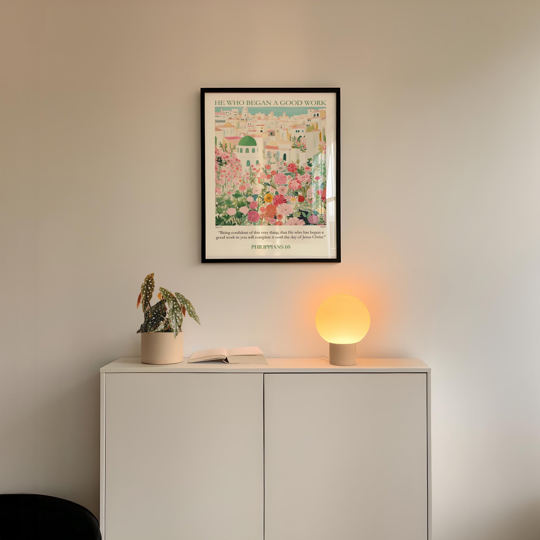 a white cabinet with a potted plant and a small lamp on top, set against a white wall.
