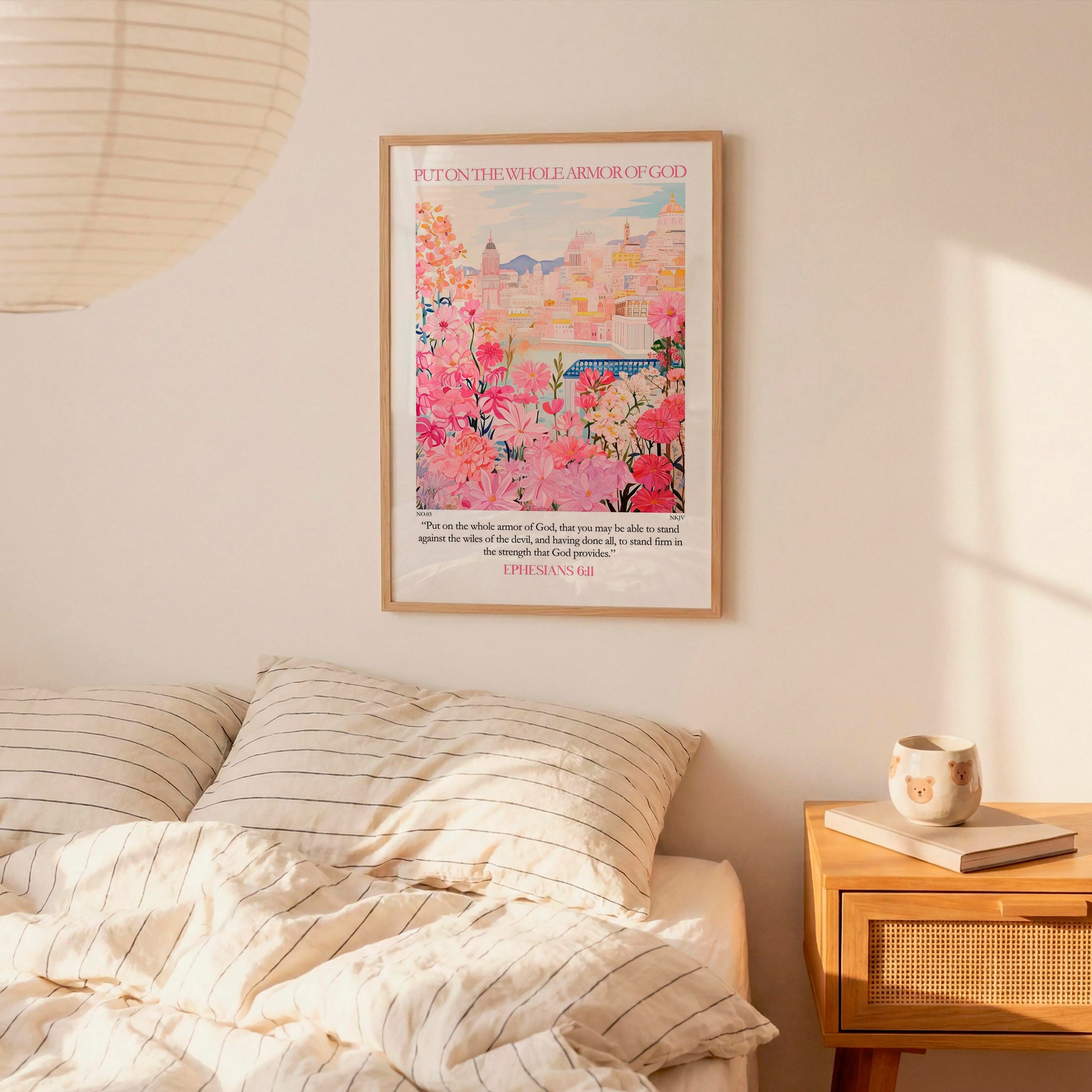 a bedroom setting with a framed poster of a colorful floral scene hanging on the wall above a bed with striped bedding.