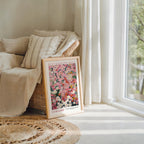 a framed poster of a floral design, placed on a rug in a living room setting.