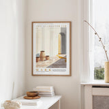 a framed poster of a room with a window, a table with books and a bowl, and a plant on a shelf.