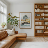 a cozy living room with a large bookshelf filled with books, a comfortable leather couch, and a large framed poster of a tree on the wall.