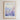 The image is a framed poster featuring a watercolor painting of a person standing in a field of purple flowers. The poster has a text overlay that reads "WHERE YOU GO I WILL GO" and "Ruth 1:16 Old Testament".