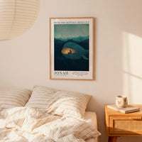 a bedroom scene with a framed poster of a whale on the wall above a bed with striped bedding.