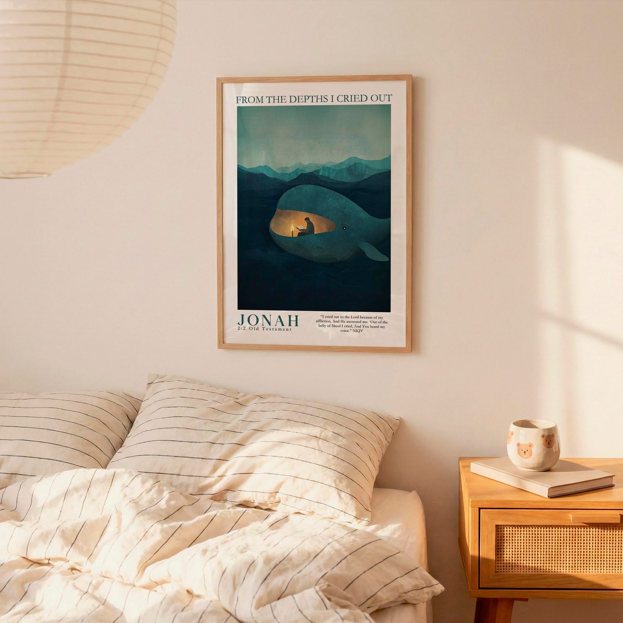 a bedroom scene with a framed poster of a whale on the wall above a bed with striped bedding.