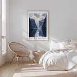 a serene bedroom scene with a large poster of a mountain landscape hanging on the wall, a woven chair, and a neatly made bed with white bedding.