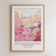 The image is a framed poster with a colorful illustration of a cityscape and flowers. The poster has a religious message and a Bible verse from Ephesians 6:11.