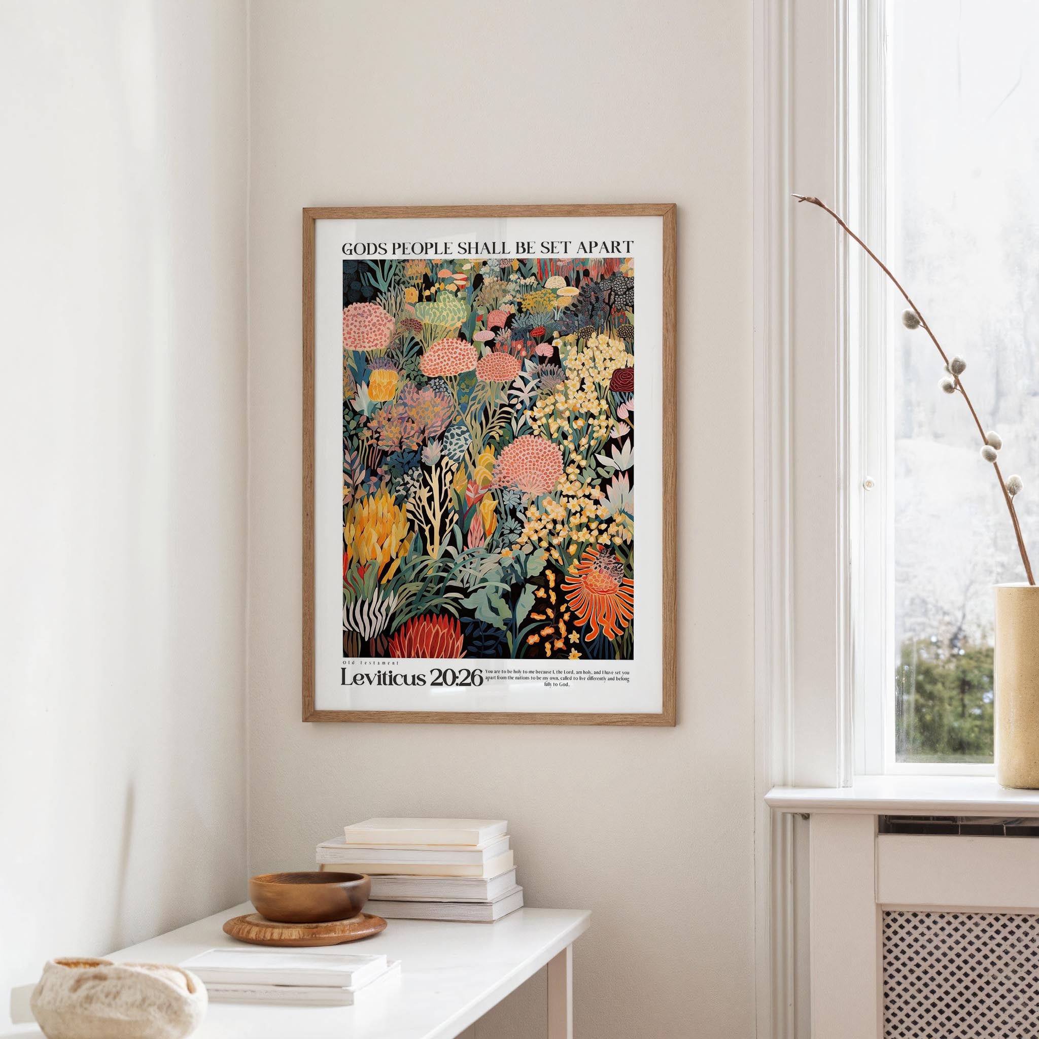 a framed poster of a colorful, abstract floral design hanging on a wall in a room.