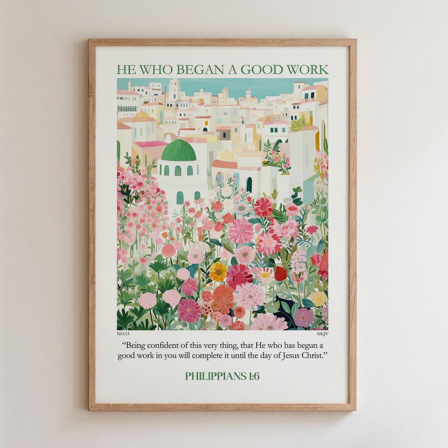 The image is a framed poster with a colorful illustration of a cityscape filled with flowers and greenery. The poster is titled "HE WHO BEGAN A GOOD WORK" and includes a quote from the Bible verse Philippians 16:1-3.