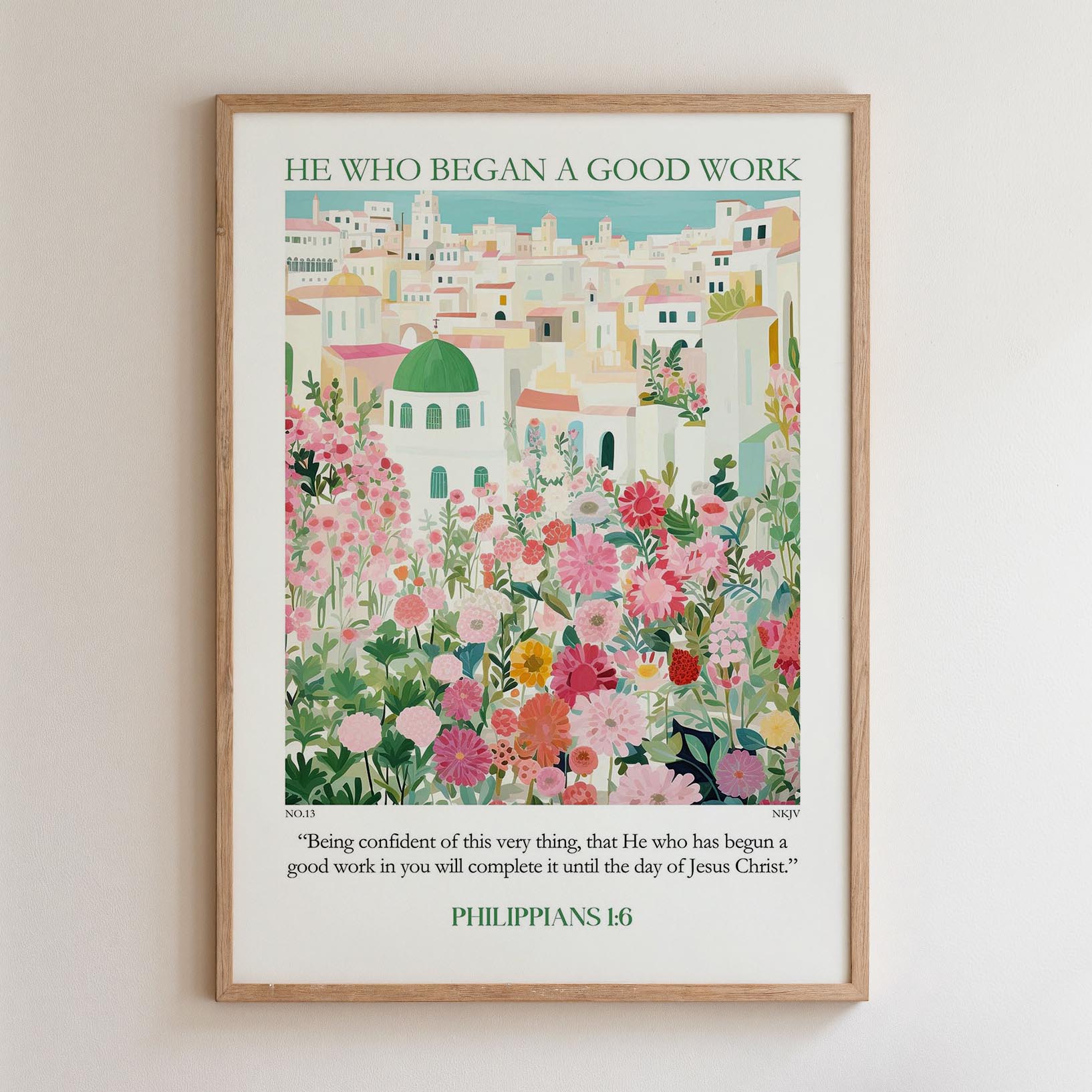 The image is a framed poster with a colorful illustration of a cityscape filled with flowers and greenery. The poster is titled "HE WHO BEGAN A GOOD WORK" and includes a quote from the Bible verse Philippians 16:1-3.