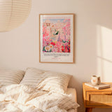 a bedroom scene with a framed poster of a colorful floral landscape hanging on the wall above a bed with striped bedding.