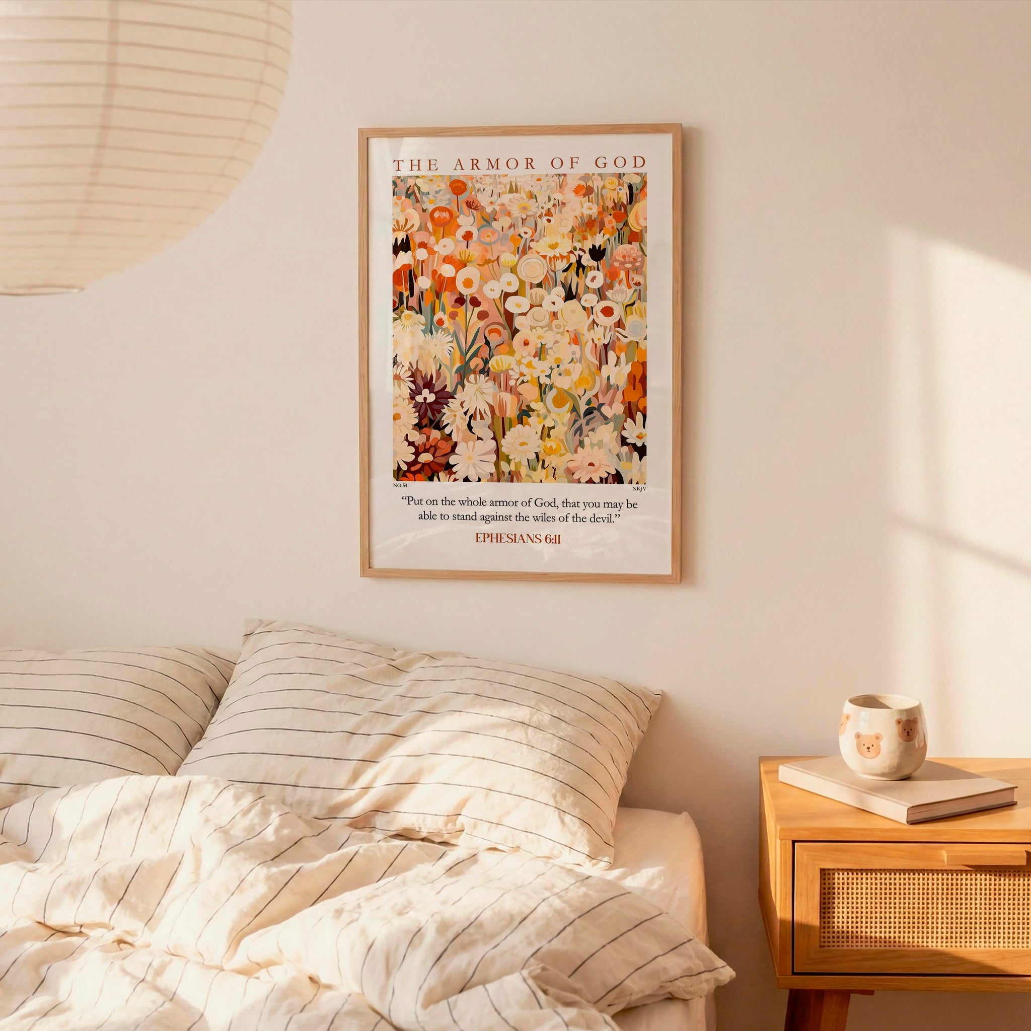 a bedroom setting with a framed poster of a floral design hanging on the wall above a bed with striped bedding.