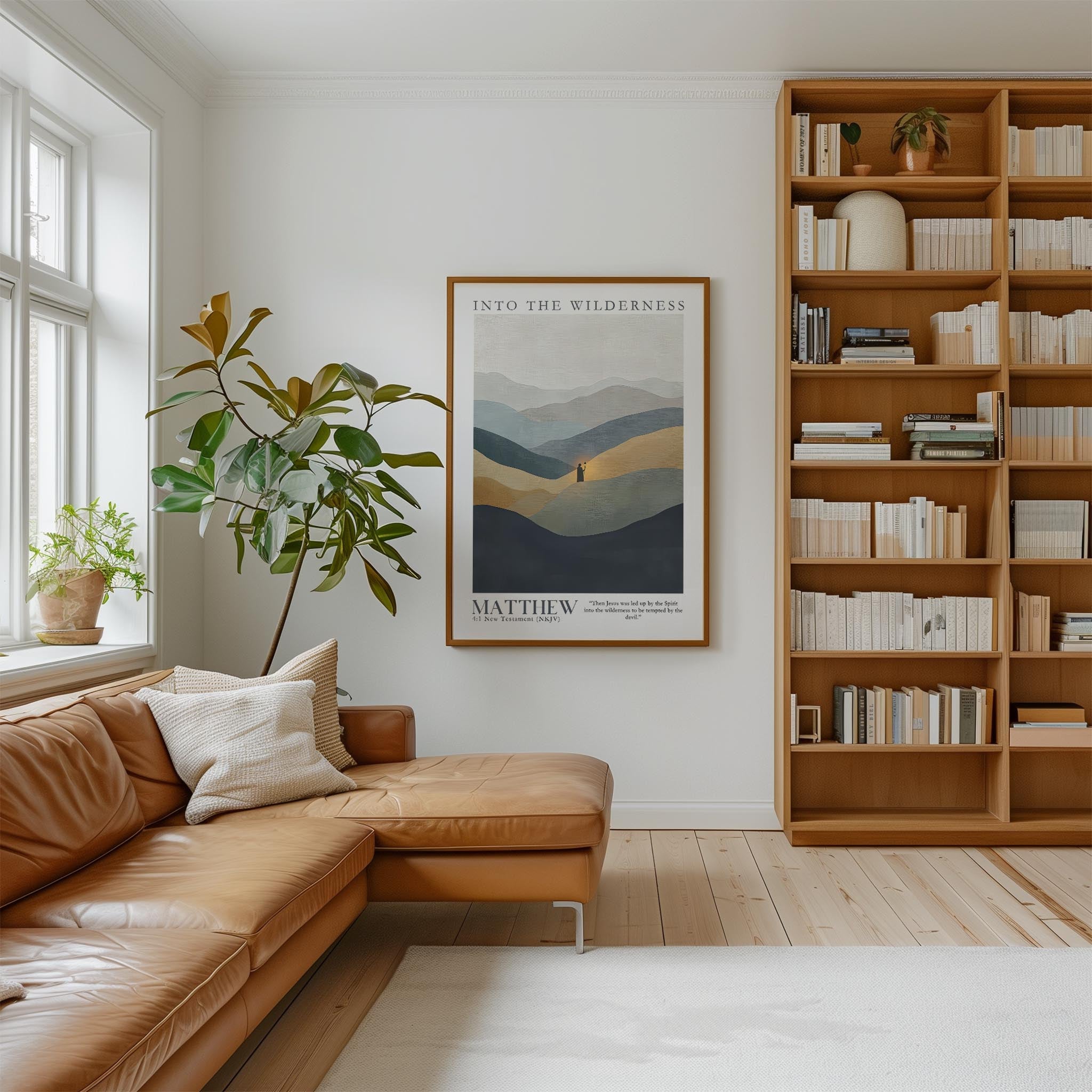 a cozy living room with a large bookshelf filled with books, a comfortable leather sofa, and a framed poster of a mountain landscape hanging on the wall.