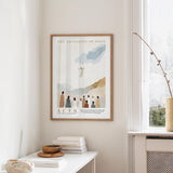 a framed poster of a religious scene hanging on a wall, with a window and a table with books and a bowl on it below.