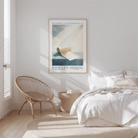 a serene bedroom scene with a bed, a woven chair, and a framed poster on the wall.