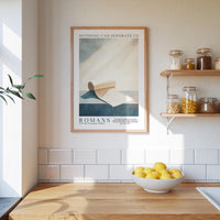 a kitchen counter with a bowl of lemons, a framed poster of a roll of toilet paper, and a shelf with various jars and containers.