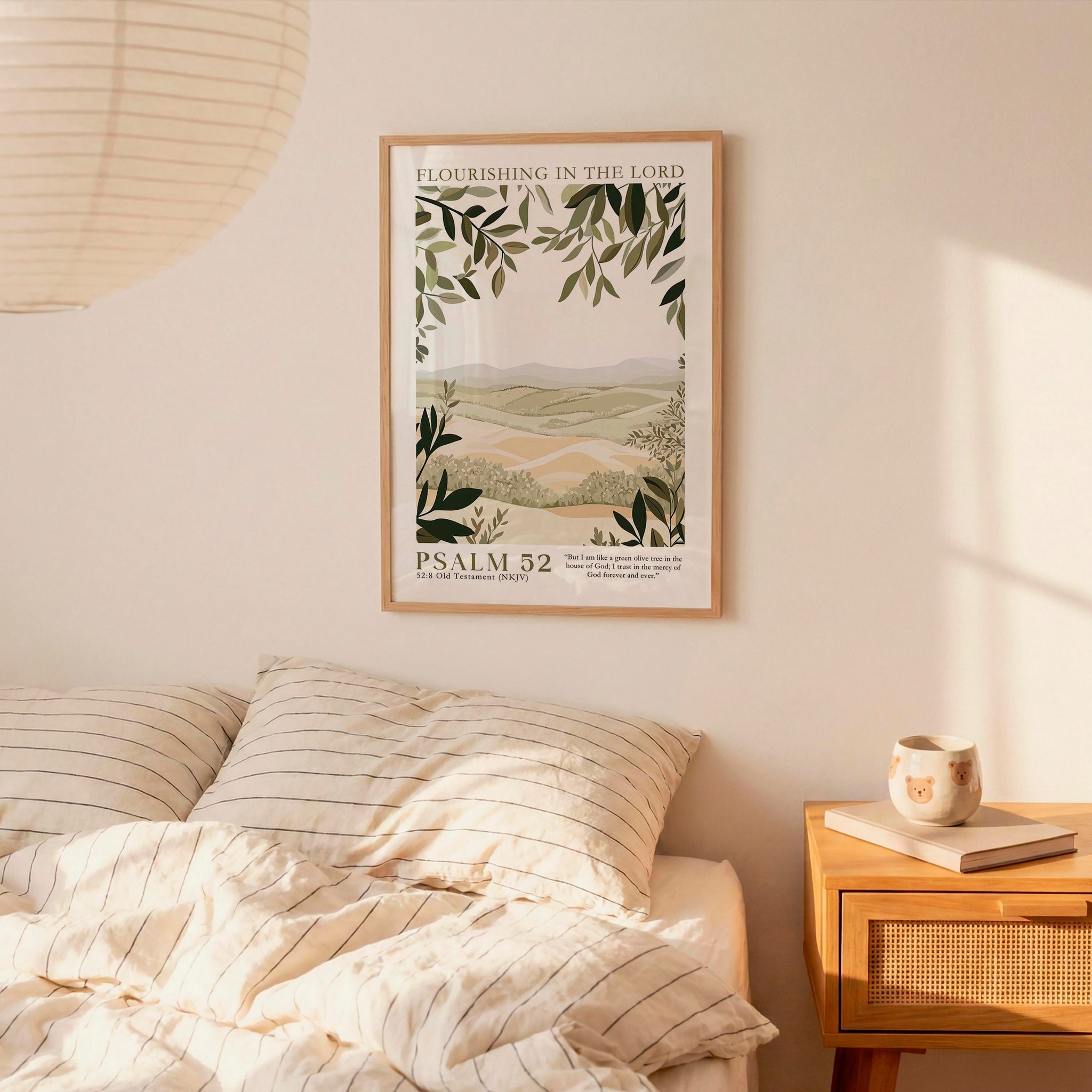 a bedroom scene with a framed poster of a landscape hanging on the wall above a bed with striped bedding.
