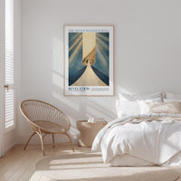 a bedroom with a bed, a woven chair, and a framed poster on the wall.