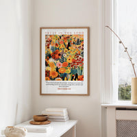 a framed poster of a colorful floral design hanging on a wall, with a quote from Proverbs 3:5 below it.