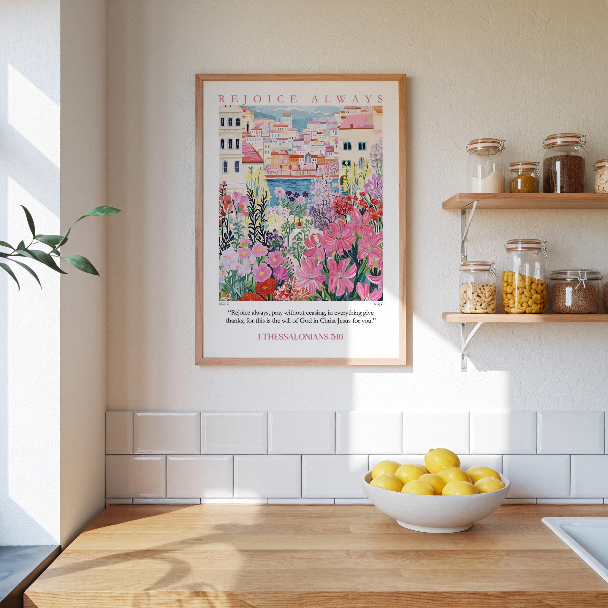 a kitchen scene with a framed poster of a colorful garden hanging on the wall above a wooden countertop with a bowl of lemons.