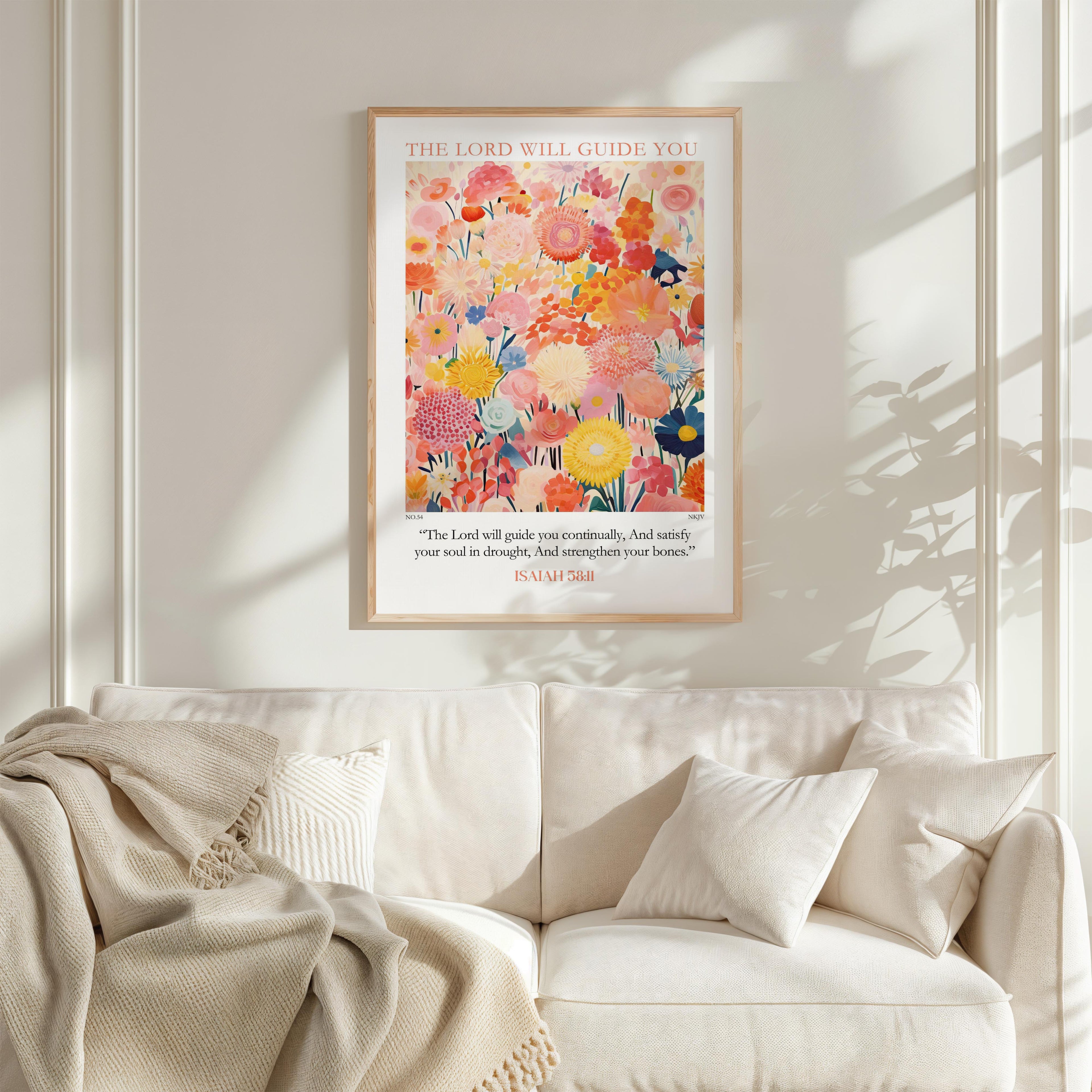 a poster of a colorful floral arrangement hanging on a wall above a white couch with pillows.