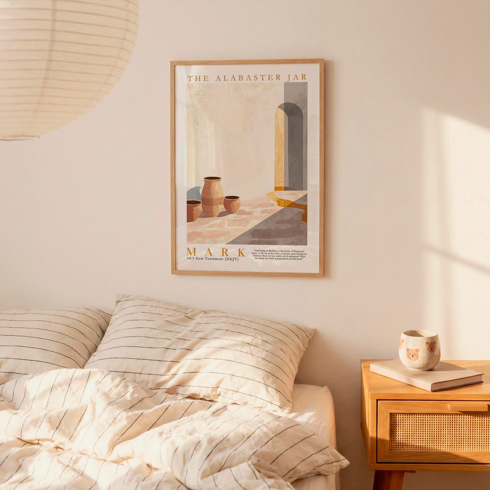 a bedroom setting with a framed poster of a desert scene hanging on the wall above a bed with striped bedding.