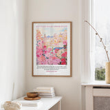 A framed poster of a colorful cityscape hangs on a wall, accompanied by a quote from Ephesians 4:1.