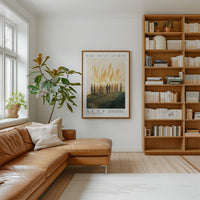 a cozy living room with a large bookshelf filled with books, a comfortable leather couch, and a framed poster of a group of people on the wall.