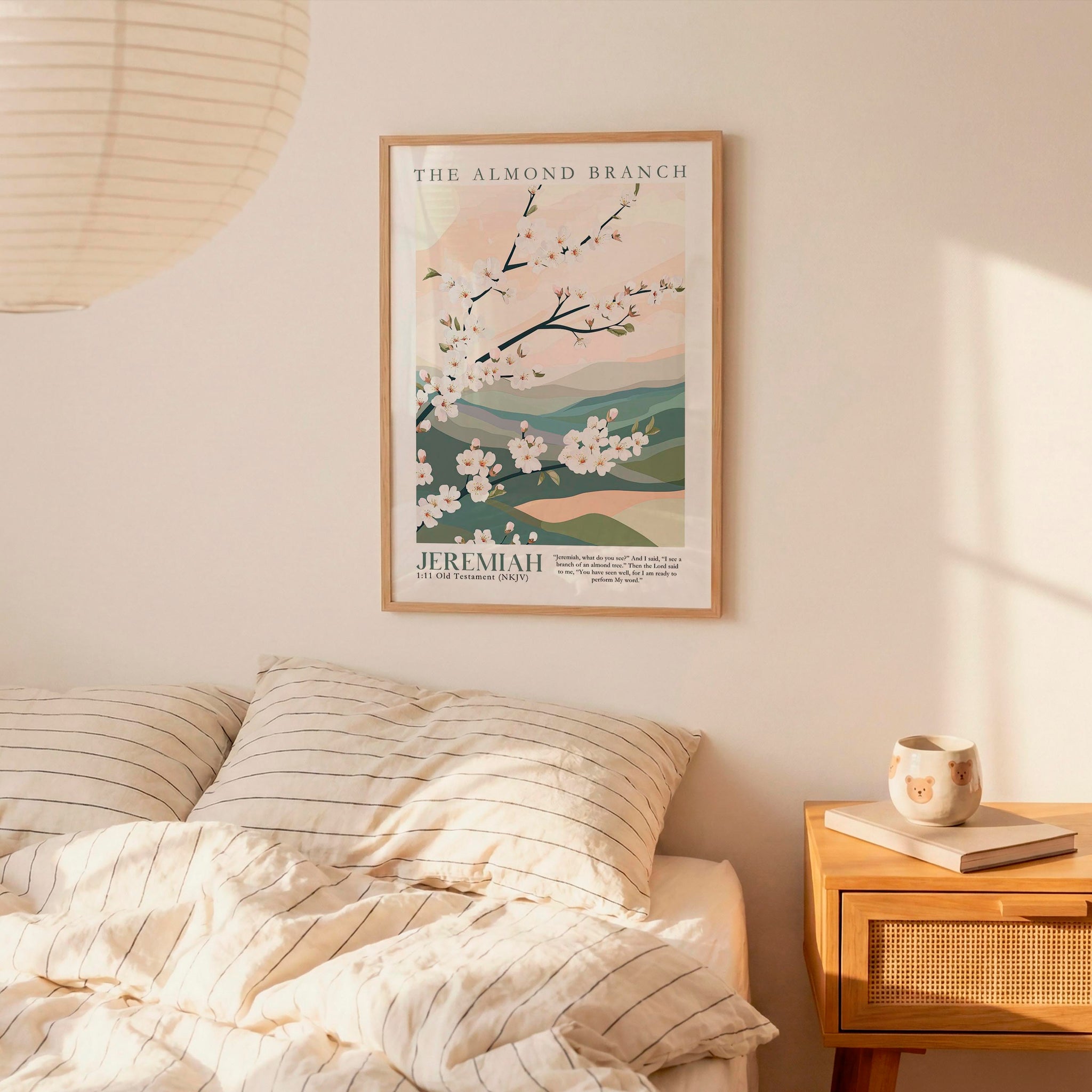 a bedroom scene with a framed poster of a floral design hanging on the wall above a bed with striped pillows.