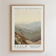 The image is a framed poster depicting a person sitting on a rocky cliff, overlooking a mountainous landscape. The poster is titled "PRAISE IN THE WILDERNESS" and includes a Bible verse from the Old Testament, "Psalm 37:7 Old Testament ( NKJV )".