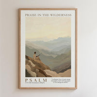 The image is a framed poster depicting a person sitting on a rocky cliff, overlooking a mountainous landscape. The poster is titled "PRAISE IN THE WILDERNESS" and includes a Bible verse from the Old Testament, "Psalm 37:7 Old Testament ( NKJV )".