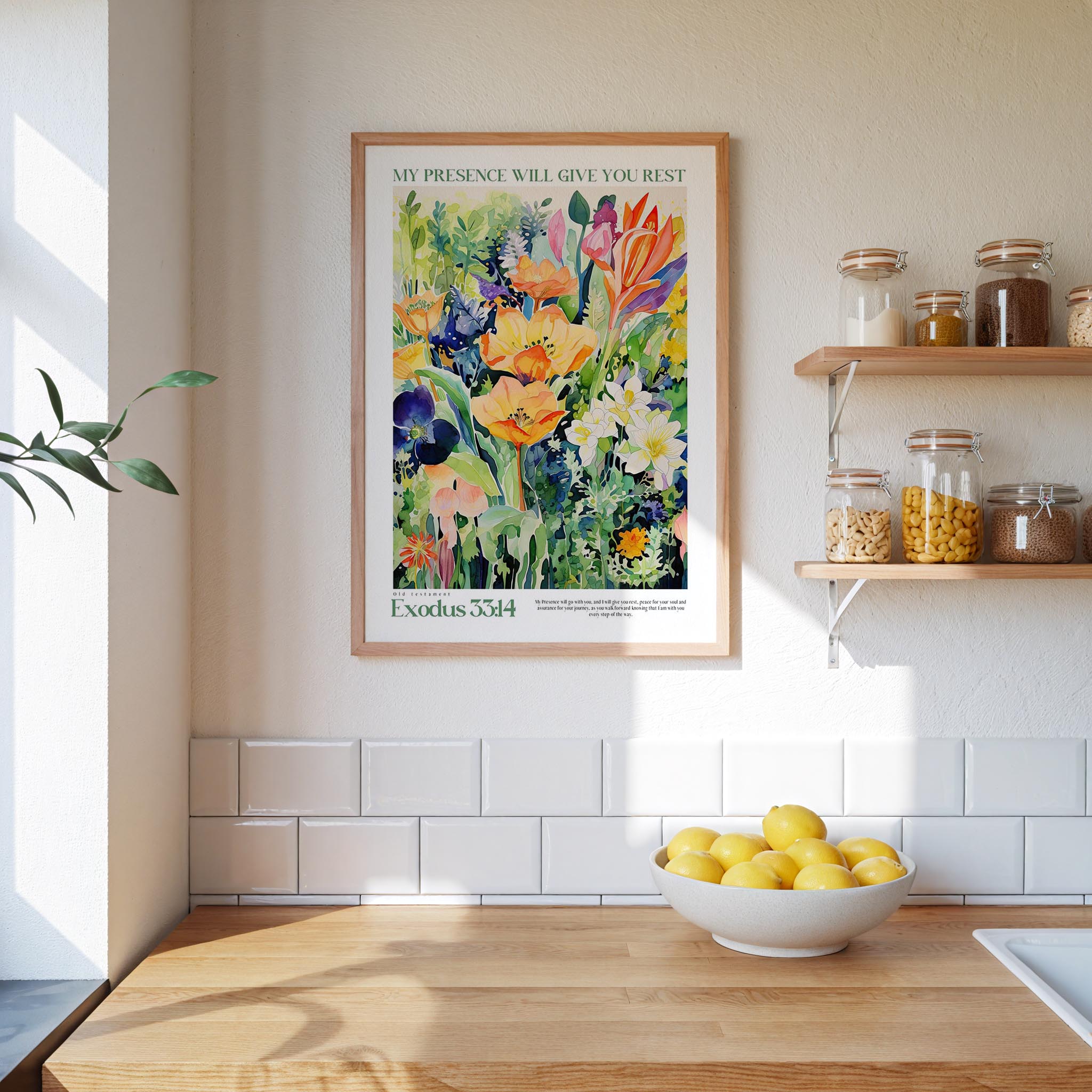 a framed poster of a colorful floral painting hanging on a wall above a wooden countertop with a bowl of lemons.