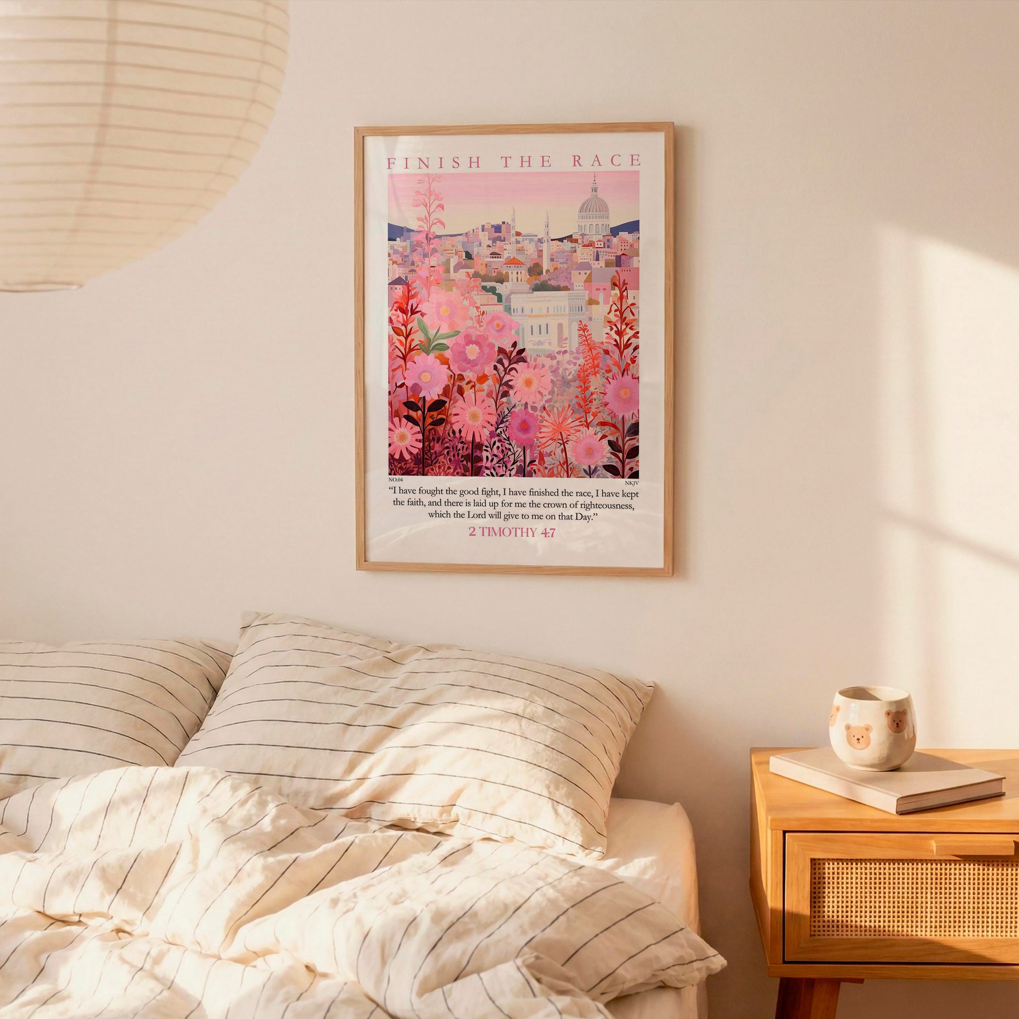 a bedroom setting with a framed poster of a cityscape hanging on the wall above a bed with striped bedding.