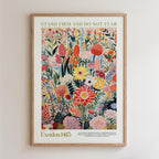 The image is a framed poster featuring a vibrant, colorful illustration of various flowers and plants. The poster includes text that reads "Stand firm and do not fear" and "Old Testament 14:13".