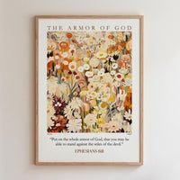 The image is a framed poster with a floral design and a Bible verse from Ephesians 6:11.