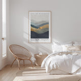 a serene bedroom scene with a large bed, a woven chair, and a framed poster of a mountain landscape.