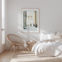 a serene bedroom scene with a bed, a woven chair, and a framed poster on the wall.