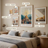a bedroom with a bed, nightstands, and various framed artworks or posters on the wall.